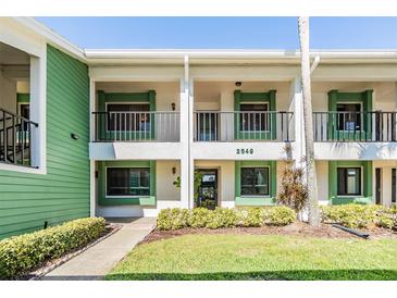 Inviting two-story condo with a lush green lawn and charming balconies, offering a warm, welcoming curb appeal at 2549 Royal Pines Cir # 16H, Clearwater, FL 33763