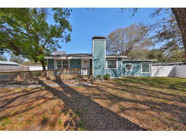 Charming single-story home with blue siding, a walkway ramp, and a chimney at 3127 W Lambright St # A, Tampa, FL 33614