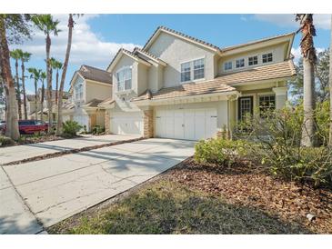 Charming townhomes with private driveways and attached garages nestled in a tree-lined community at 14532 Mirabelle Vista Cir, Tampa, FL 33626