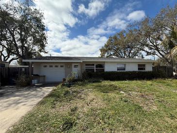 Charming single Gathering home featuring an attached garage and mature trees at 14998 Mockingbird Ln, Clearwater, FL 33760