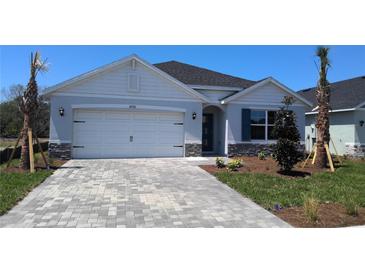 Charming single-story home featuring a brick-paved driveway and well-maintained landscaping at 17036 James Trl, Parrish, FL 34219