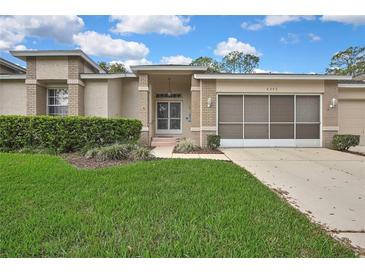 Charming single-story home with brick accents, well-manicured lawn, and inviting entrance at 2343 Hidden Trail Dr, Spring Hill, FL 34606