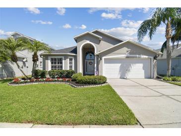 Charming single Gathering home with a well maintained lawn and beautiful Florida landscaping at 31101 Wrencrest Dr, Wesley Chapel, FL 33543