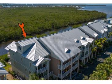 Stunning waterfront condo featuring a durable metal roof and balconies overlooking the serene river at 3230 Mangrove Point Dr, Ruskin, FL 33570