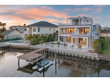 Waterfront home with modern design, dock, pool, and beautiful sunset views at 521 Baywood S Dr, Dunedin, FL 34698