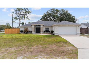 Charming single-story home with well-maintained landscaping, a two-car garage, and a welcoming front entrance at 10424 Gifford Dr, Spring Hill, FL 34608