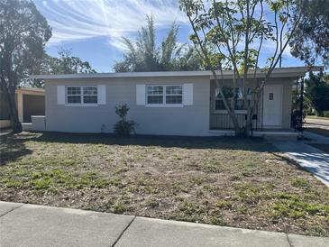 Charming single-story home with white trim, a well-manicured lawn and sidewalk at 576 62Nd S Ave, St Petersburg, FL 33705