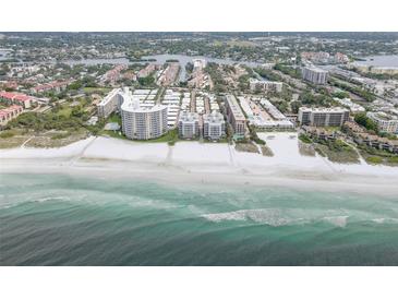 Stunning aerial view of beachfront condos with pristine white sand and turquoise waters at 6310 Midnight Pass Rd # 204N, Sarasota, FL 34242