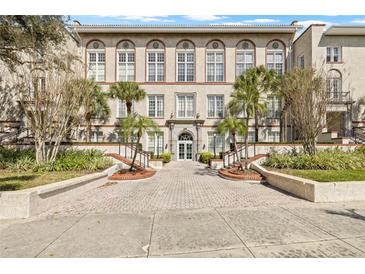 Beautiful exterior of building with multiple large windows, palm trees, and landscaped entrance at 701 Mirror Lake N Dr # 216, St Petersburg, FL 33701