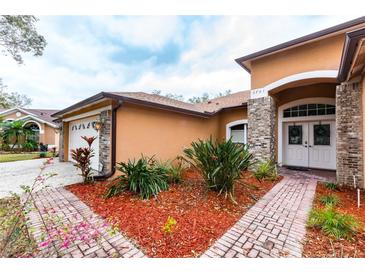 Charming single-story home with well-maintained landscaping, brick accents, and a welcoming double-door entrance at 3701 Barnhouse Pl, Valrico, FL 33596