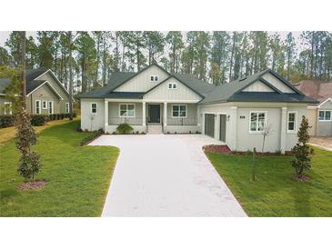 Beautifully landscaped front yard with a modern home design and long paver driveway at 4507 Majestic Hill Loop, Brooksville, FL 34601