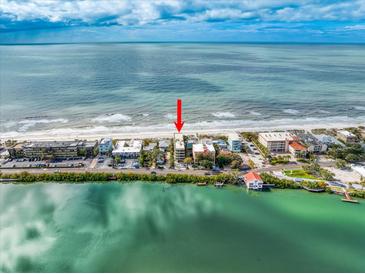 Breathtaking aerial view of beachfront property with stunning ocean views at 74 Gulf Blvd # 2B, Indian Rocks Beach, FL 33785