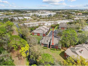 Scenic aerial view of brick condos surrounded by lush greenery, waterway, and city views at 9100 Dr Martin Luther King Jr N St # 1508, St Petersburg, FL 33702