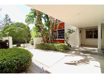 Inviting courtyard entrance with lush tropical landscaping, plants, and a secure gated entryway at 2630 Pearce Dr # 107, Clearwater, FL 33764