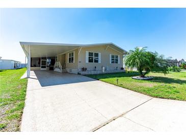 Charming single-story home with neutral siding, carport, and well-maintained landscaping and a concrete driveway at 36838 Tara Ave, Zephyrhills, FL 33542