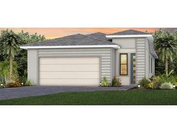 Modern home showcasing a two-car garage and decorative landscaping at 5018 Coastal Oak Ct, Lakewood Ranch, FL 34211
