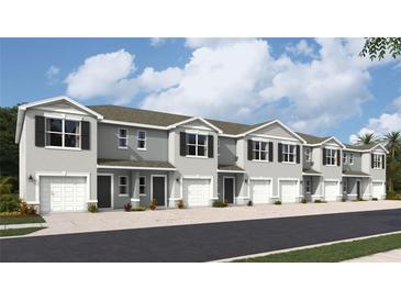 Charming two-story townhomes with attached garages and neutral gray paint at 17437 Haysack Ter, Lakewood Ranch, FL 34211