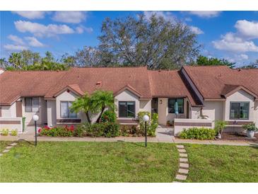 Charming single-story villa with well-maintained landscaping, healthy green lawn, and stepping stone walkway at 6004 36Th Avenue W Cir # B, Bradenton, FL 34209