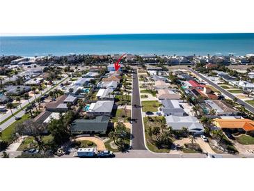 Aerial view of the neighborhood with blue ocean in the distance at 102 23Rd St, Belleair Beach, FL 33786