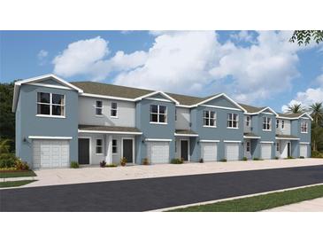 Row of two-story townhomes featuring blue paint, light-colored doors, and a garage at 4113 Goldheart Blvd, Bradenton, FL 34208