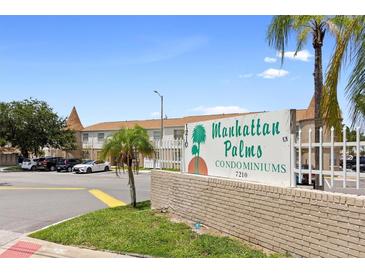Manhattan Palms Condominiums with manicured grounds and prominent signage in a well-maintained community setting at 7210 N Manhattan # 1822, Tampa, FL 33614