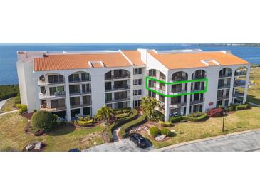 Stunning waterfront condo with lush landscaping and classic Mediterranean architecture, offering serene coastal living at 438 Mariner Dr, Tarpon Springs, FL 34689