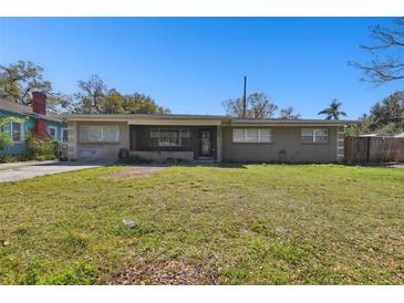 Charming single story home with a spacious lawn and a screened-in front porch at 200 W Louisiana Ave, Tampa, FL 33603