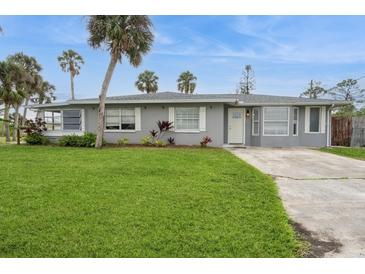 Charming single-story home with a well-manicured lawn, complemented by palm trees for a tropical touch at 112 Rose St, Venice, FL 34293