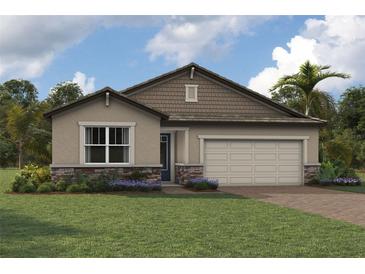 Charming single-story home featuring stone accents and a well-maintained lawn at 18585 Watercolor Ave, Venice, FL 34293