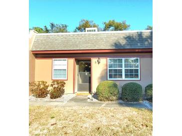 Charming single-story home featuring a well-manicured lawn and a welcoming entrance at 11204 Pembridge Ct # 5, Port Richey, FL 34668
