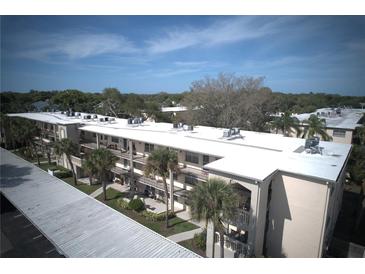 Well-maintained condo complex featuring lush landscaping, a covered walkway, and a serene atmosphere at 11620 Park Blvd # 308, Seminole, FL 33772