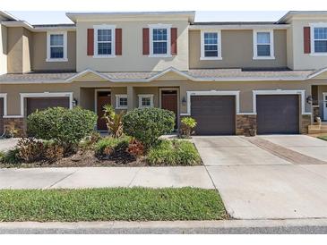 Charming townhome with manicured landscaping, attached garages, and inviting curb appeal at 1308 Syrah Dr, Oldsmar, FL 34677