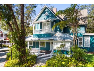 Charming two-story home with blue siding, white trim, and inviting front porch at 26 W Orange St, Tarpon Springs, FL 34689