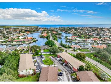 Panoramic aerial view of waterfront homes, canals, and community near the ocean under blue sky at 4570 Overlook Ne Dr # 282, St Petersburg, FL 33703