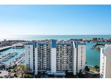 Expansive view of waterfront condo building with marina, ocean and harbor at 9525 Blind Pass Rd # 301, St Pete Beach, FL 33706