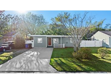Charming home with a well-manicured lawn and a concrete driveway at 304 David Ave, Clearwater, FL 33759