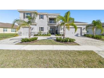 Elegant two-story home boasts a three-car garage and meticulous landscaping with lush palm trees at 3280 Juniper Springs St, Wesley Chapel, FL 33543