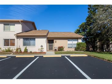 Charming single-story condo with assigned parking and well-maintained landscaping at 3857 Sailmaker Ln, Holiday, FL 34691