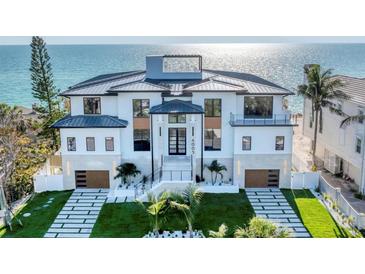 Stunning beachfront home with modern design, lush landscaping, and direct ocean views at 4005 Casey Key Rd, Nokomis, FL 34275