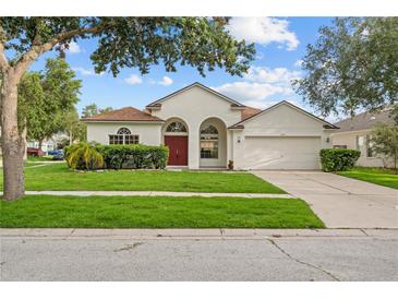 Inviting single-story home featuring a manicured lawn and a charming facade at 11611 Jordans Landing Ct, Riverview, FL 33569