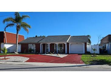 Charming one-story brick home featuring a driveway with a one car garage and mature landscaping at 3506 Moog Rd, Holiday, FL 34691