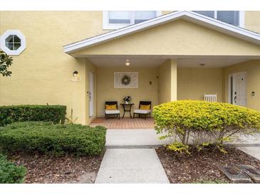 Charming front porch with seating area and decorative wreath, creating a welcoming entrance at 423 Shaddock St, Tarpon Springs, FL 34689