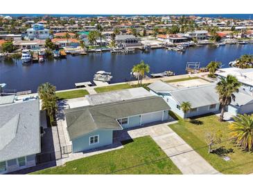 Waterfront home boasts lush landscaping, boat dock, and canal access to the ocean at 5321 Bowline Bnd, New Port Richey, FL 34652