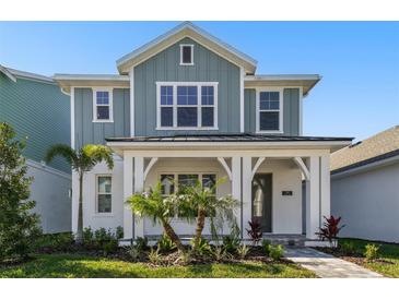 Charming two-story home with a covered front porch and beautiful landscaping, creating great curb appeal at 7266 Kodiak Ln, Sarasota, FL 34240
