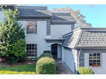 Charming home with landscaped front yard, showcasing the architectural details and inviting entrance at 1321 N Mcmullen Booth Rd # 1321, Clearwater, FL 33759