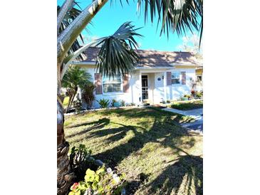 Charming single story home with manicured lawn, mature shade trees and classic exterior at 1616 S Lake Ave # 4, Clearwater, FL 33756