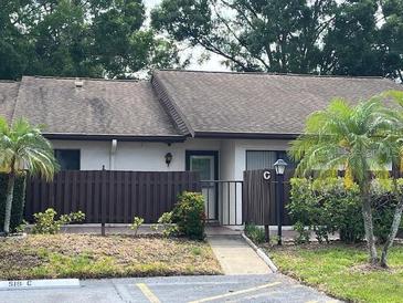 Charming one-story condo with a well-maintained front yard and covered entrance at 1725 Pine Ridge E Way # C, Palm Harbor, FL 34684