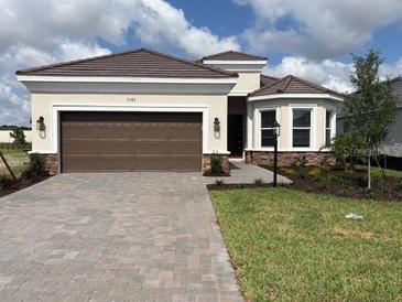 Charming single-story home with a two-car garage, manicured lawn, and beautiful landscaping at 3583 Santa Caterina Blvd, Bradenton, FL 34211
