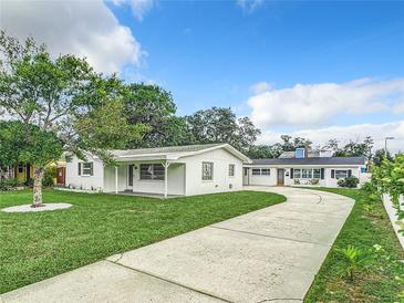 Charming single-story home with well-manicured lawn and a concrete driveway at 405 S Lake Dr, Clearwater, FL 33755