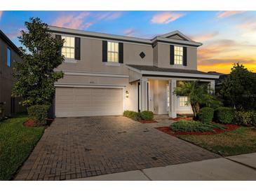 Charming two-story home featuring a well-manicured lawn and brick paved driveway at 4195 Welling Ter, Land O Lakes, FL 34638